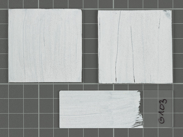 Three plates of glass or transparent plastic covered with white paint